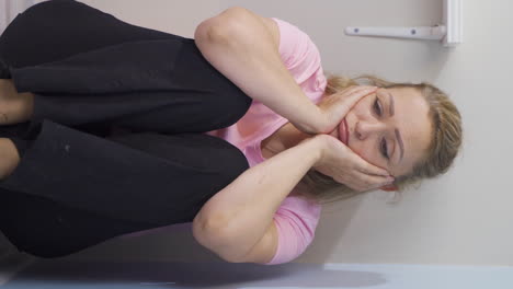 Vertical-video-of-Depressed-woman-covering-her-face-with-her-hand.